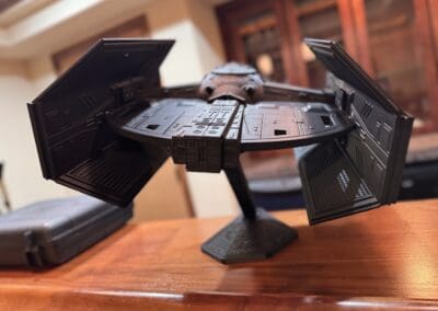Detailed Millennium Falcon model from Star Wars on a wooden table.